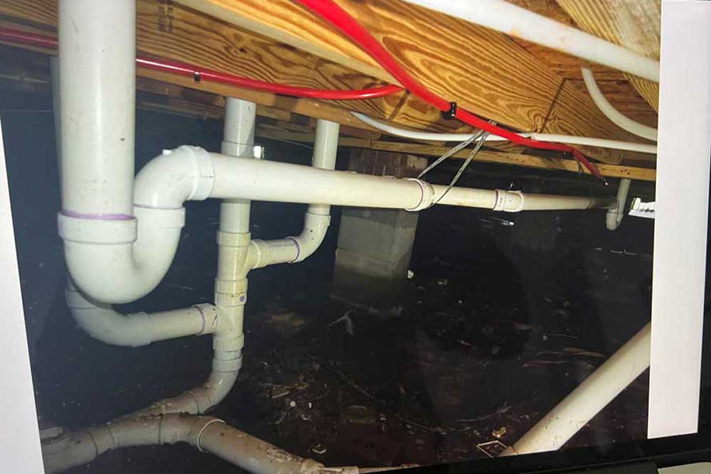 New PVC drain lines installed in a crawlspace